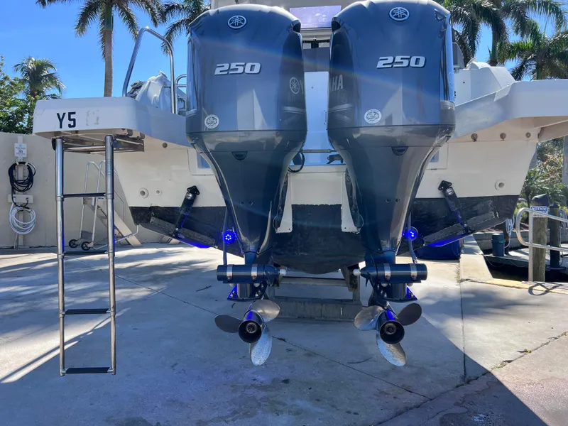 Slide: The Image of 2021 Jeanneau Leader 9.0 WA with twin Yamaha 250 engines, docked with ladder. - 9