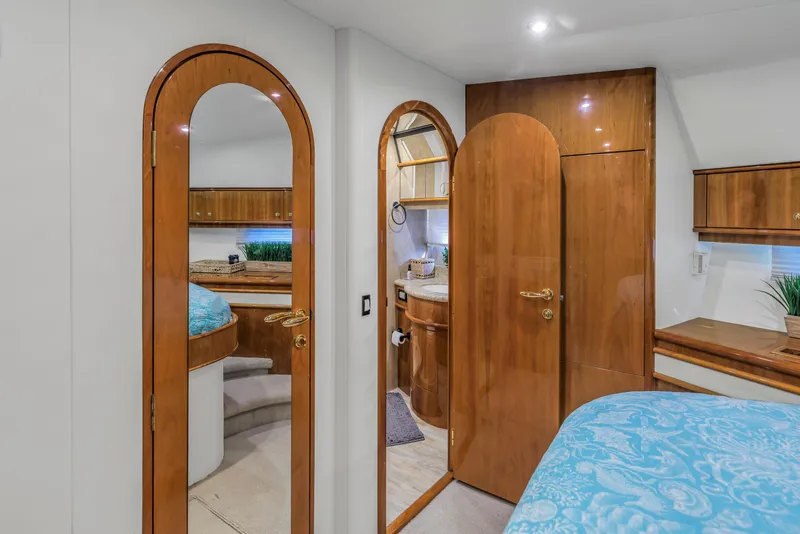 Slide: The Image of Luxurious 2007 Neptunus 62 Flybridge yacht interior with elegant wood finishes and cozy bedroom. - 12