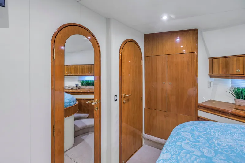 Slide: The Image of Luxurious 2007 Neptunus 62 Flybridge yacht interior with wood finishes and elegant bedroom decor. - 13