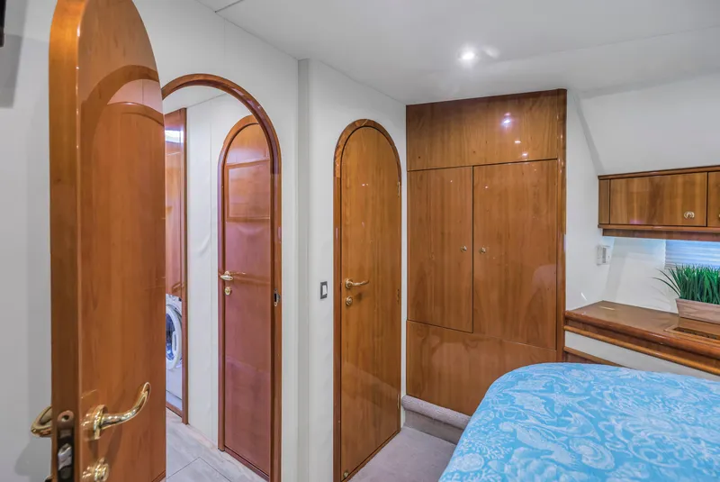 Slide: The Image of Luxurious 2007 Neptunus 62 Flybridge yacht interior with wooden doors and elegant bedroom. - 14