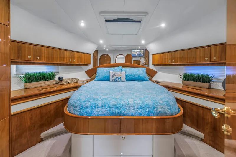 Slide: The Image of Luxurious 2007 Neptunus 62 Flybridge yacht bedroom with elegant wood finishes and blue bedding. - 15