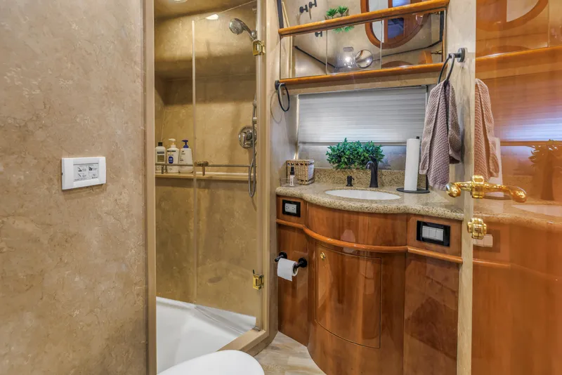 Slide: The Image of Luxurious bathroom in 2007 Neptunus 62 Flybridge yacht with elegant wood cabinetry and glass shower. - 21