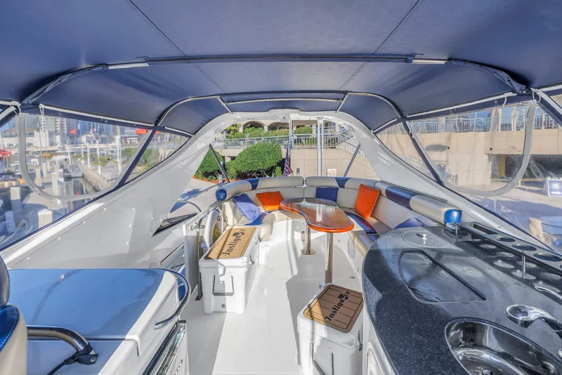Slide: The Image of 2007 Neptunus 62 Flybridge yacht interior with seating, table, and kitchenette. - 33