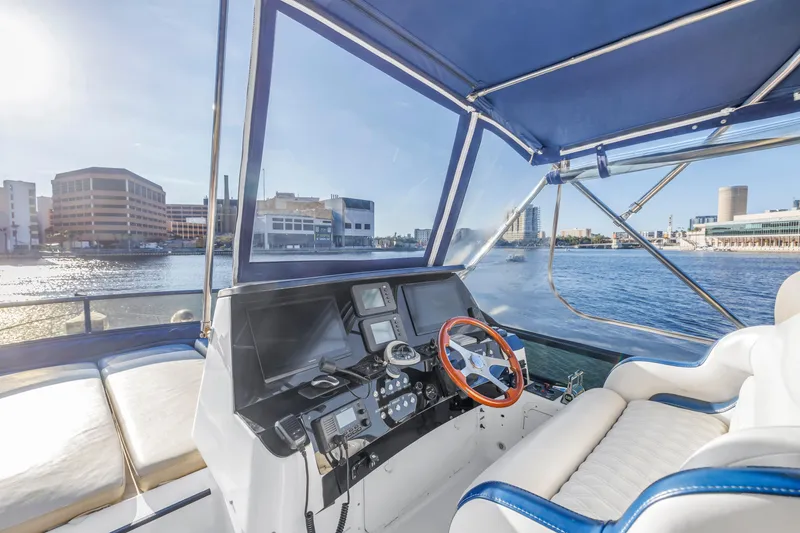 Slide: The Image of Luxurious 2007 Neptunus 62 Flybridge yacht helm with waterfront city view. - 34