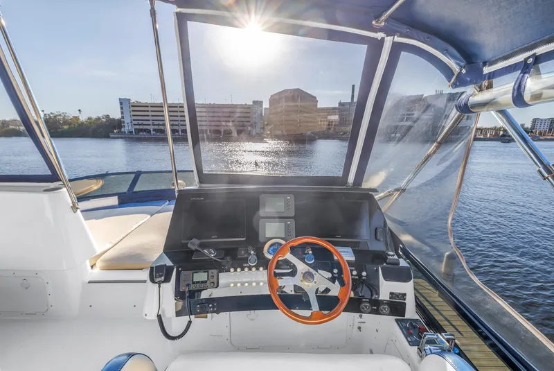 Slide: The Image of 2007 Neptunus 62 Flybridge yacht helm with waterfront view and modern controls. - 36
