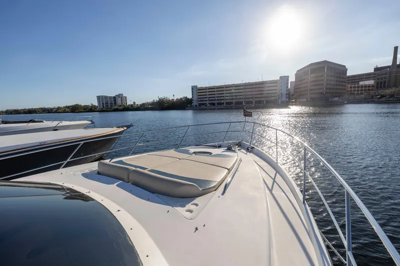 Slide: The Image of 2007 Neptunus 62 Flybridge yacht on calm water with cityscape background. - 44
