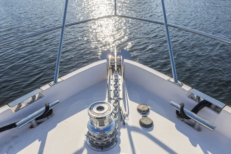 Slide: The Image of Bow of 2007 Neptunus 62 Flybridge yacht on water, sunlight reflecting. - 48