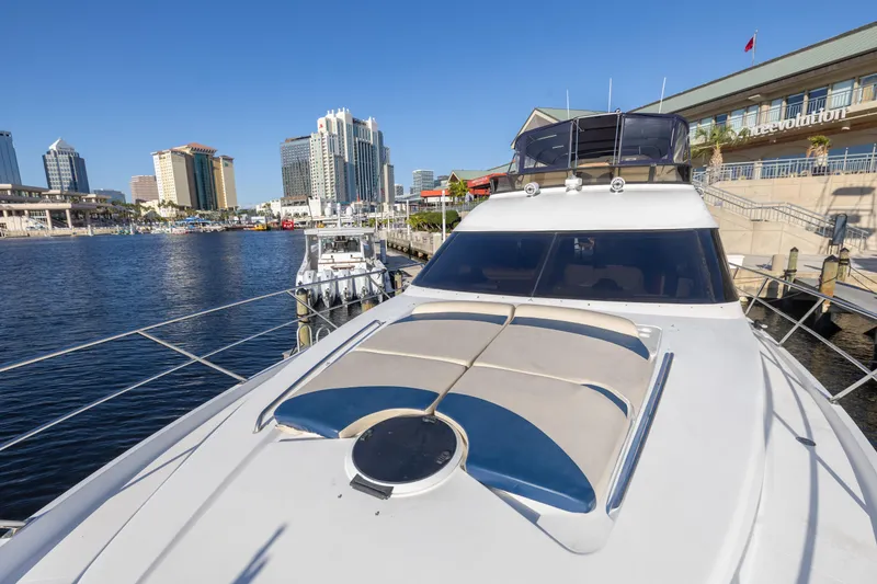 Slide: The Image of 2007 Neptunus 62 Flybridge yacht docked in urban marina with city skyline. - 49