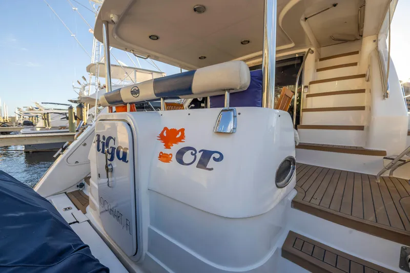 Slide: The Image of 2007 Neptunus 62 Flybridge yacht with wooden steps and marina background. - 8