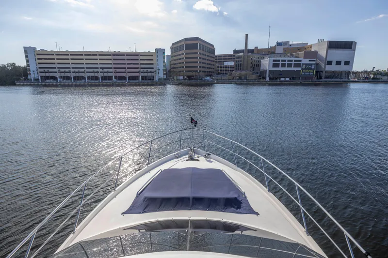 Slide: The Image of Bow view of 2007 Neptunus 62 Flybridge yacht on calm water near urban buildings. - 9