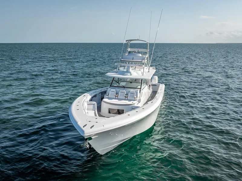 Slide: The Image of 2023 Yellowfin 54 boat cruising on open sea under clear sky. - 10