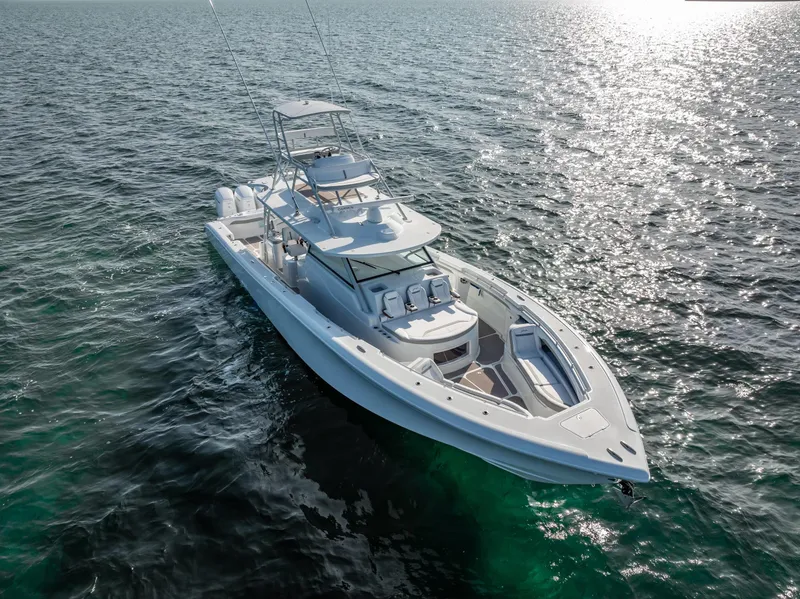 Slide: The Image of 2023 Yellowfin 54 boat cruising on open water under clear skies. - 12