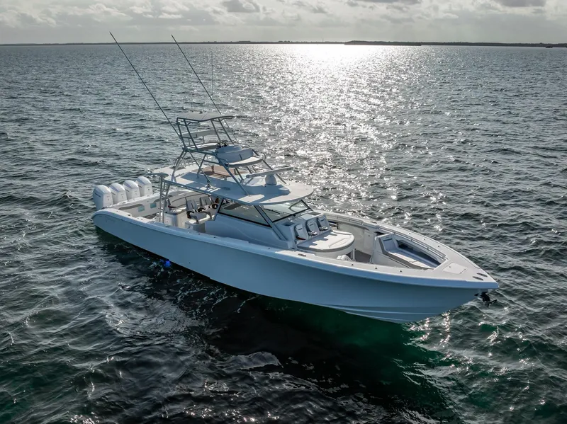 Slide: The Image of 2023 Yellowfin 54 boat cruising on open water under a bright sky. - 13