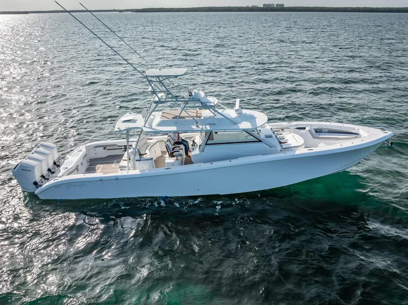 Slide: The Image of 2023 Yellowfin 54 boat cruising on open water, showcasing sleek design and powerful engines. - 14