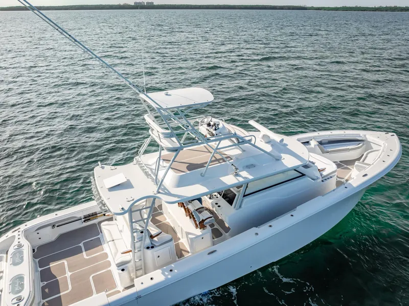 Slide: The Image of 2023 Yellowfin 54 boat on open water, showcasing sleek design and spacious deck. - 17