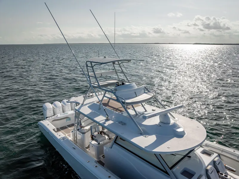 Slide: The Image of 2023 Yellowfin 54 boat on open water, featuring sleek design and multiple outboard engines. - 18