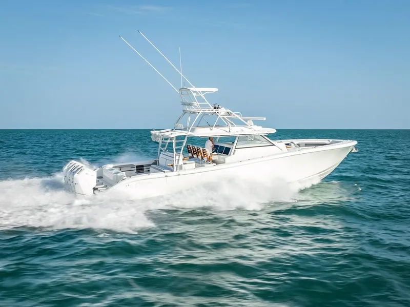 Slide: The Image of 2023 Yellowfin 54 boat cruising on open sea under clear blue sky. - 25