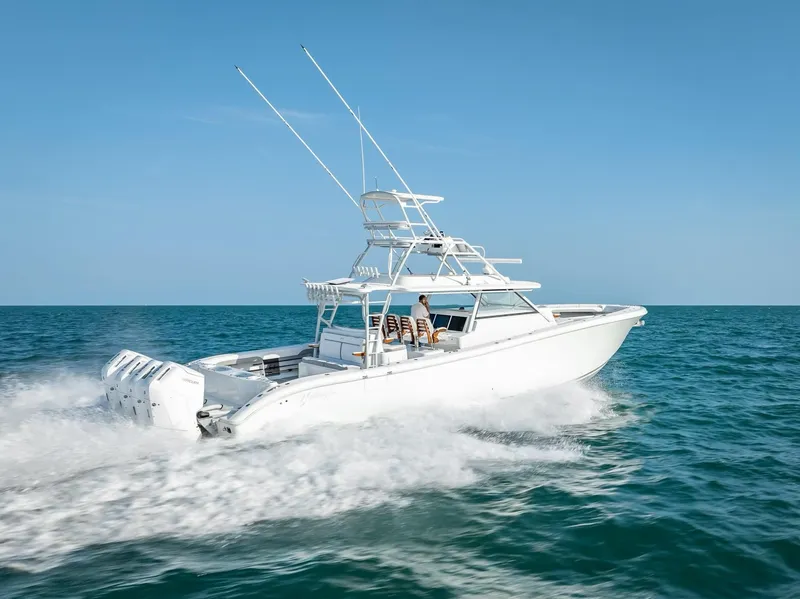 Slide: The Image of 2023 Yellowfin 54 boat cruising on open sea under clear blue sky. - 26