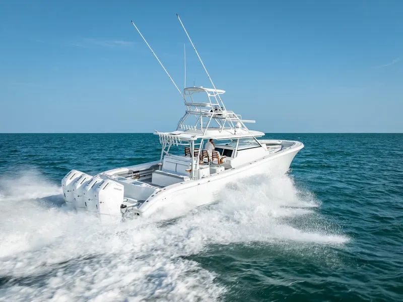 Slide: The Image of 2023 Yellowfin 54 boat cruising on open sea under clear blue sky. - 28