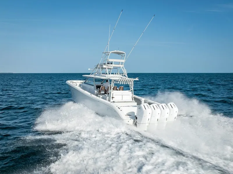 Slide: The Image of 2023 Yellowfin 54 boat cruising on open ocean with clear blue sky. - 32