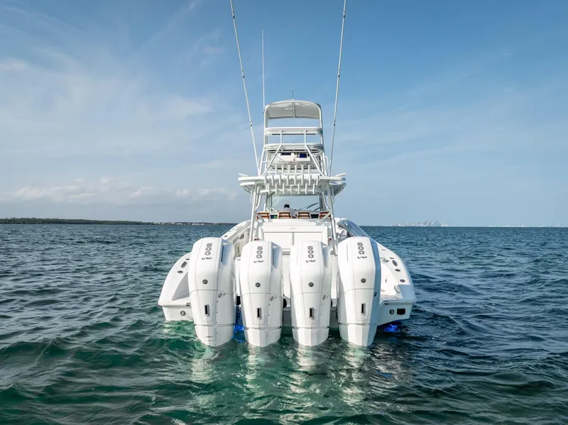 Slide: The Image of 2023 Yellowfin 54 boat with multiple outboard engines on open water. - 5