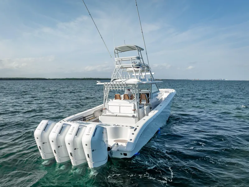 Slide: The Image of 2023 Yellowfin 54 boat with multiple outboard engines on open water. - 6