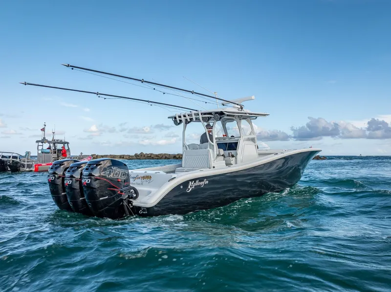 Slide: The Image of 2019 Yellowfin 34 boat with triple engines cruising on open water. - 12