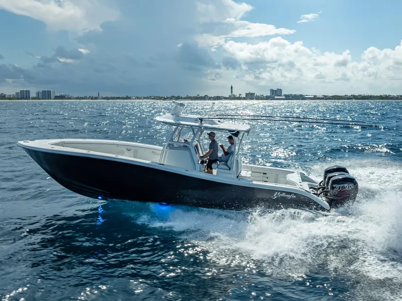 Slide: The Image of 2019 Yellowfin 34 boat cruising on open water under a partly cloudy sky. - 2