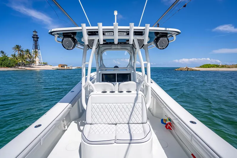Slide: The Image of 2019 Yellowfin 34 boat on water near lighthouse and tropical island. - 22