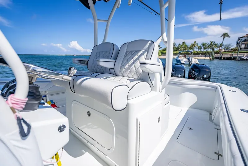 Slide: The Image of 2019 Yellowfin 34 boat interior with cushioned seating, ocean view, and clear blue sky. - 24