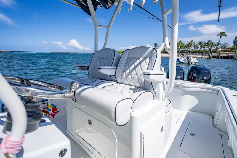 Slide: The Image of 2019 Yellowfin 34 boat interior with luxurious seating, ocean view, and clear blue sky. - 25