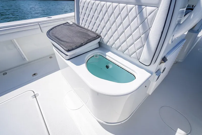 Slide: The Image of 2019 Yellowfin 34 boat interior with cushioned seating and built-in storage. - 29