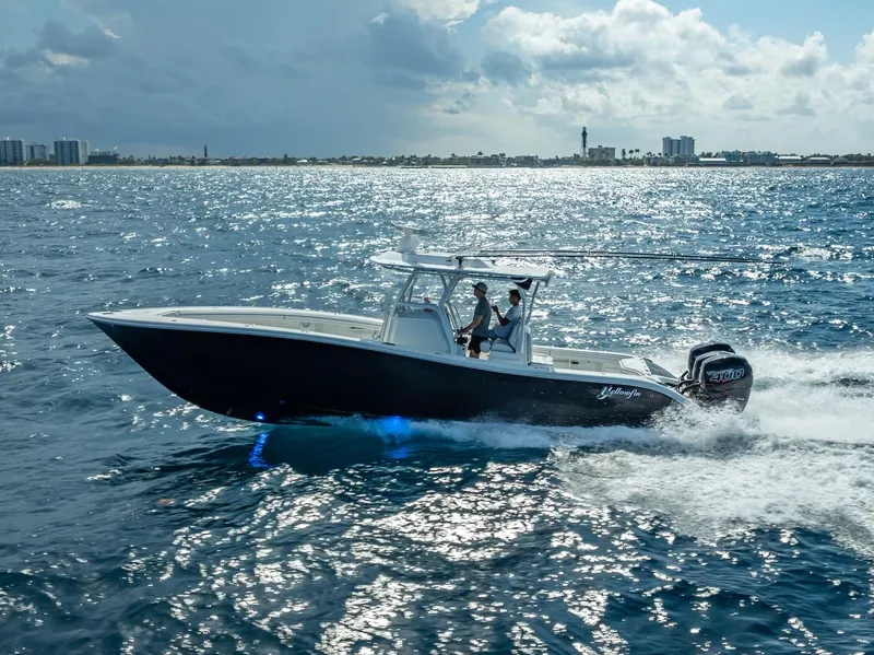Slide: The Image of 2019 Yellowfin 34 boat cruising on open water under cloudy sky. - 3
