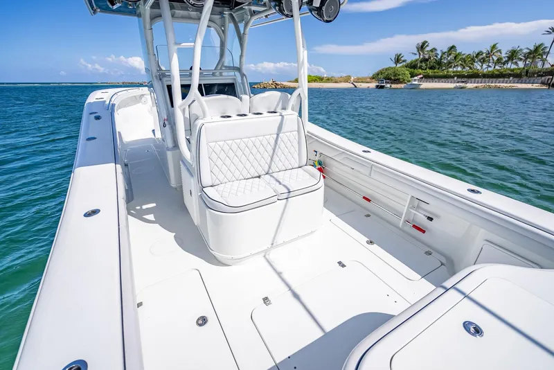 Slide: The Image of 2019 Yellowfin 34 boat on clear water, featuring spacious deck and seating. - 31