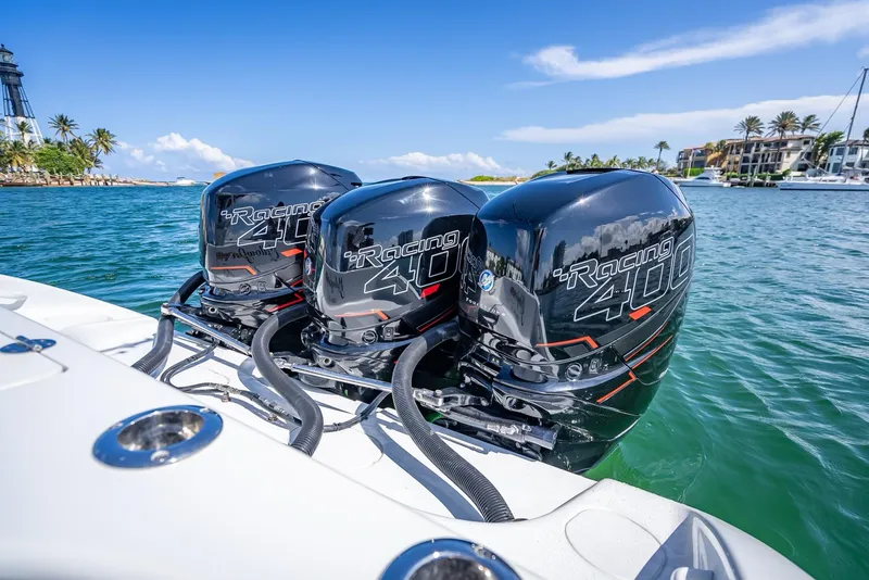 Slide: The Image of 2019 Yellowfin 34 boat with triple outboard engines on clear blue water. - 33