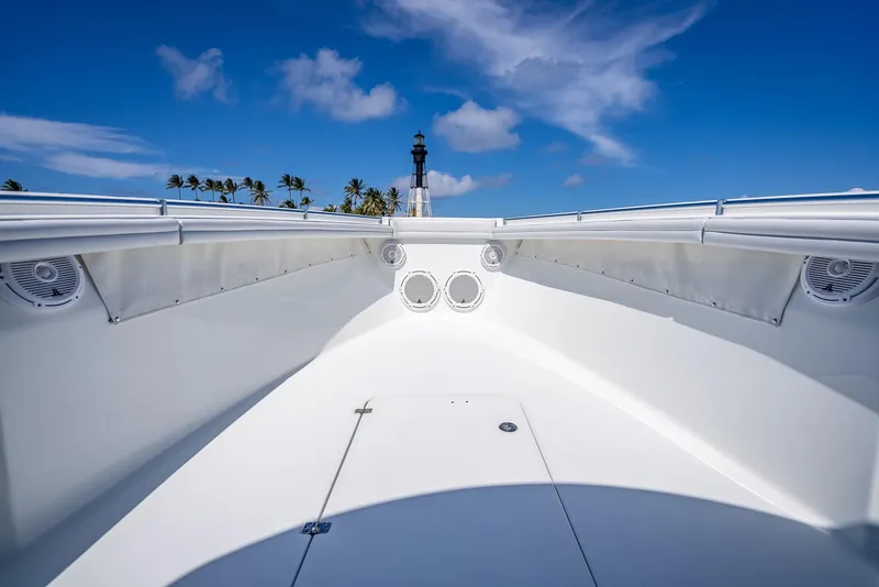 Slide: The Image of 2019 Yellowfin 34 boat interior with clear blue sky and palm trees. - 38