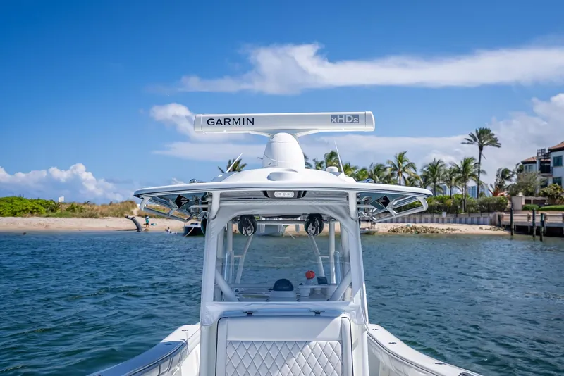 Slide: The Image of 2019 Yellowfin 34 boat with Garmin radar, cruising near a tropical shoreline. - 39