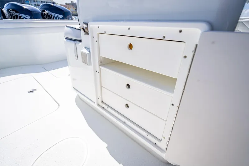 Slide: The Image of 2019 Yellowfin 34 boat interior with storage compartments and outboard motors. - 45