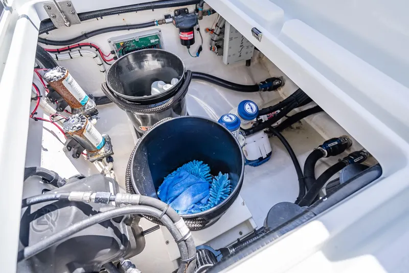 Slide: The Image of 2019 Yellowfin 34 boat engine compartment with maintenance tools and equipment. - 47