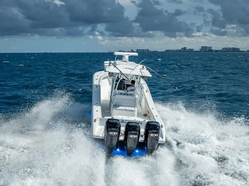 Slide: The Image of 2019 Yellowfin 34 boat cruising on ocean with triple outboard engines. - 6