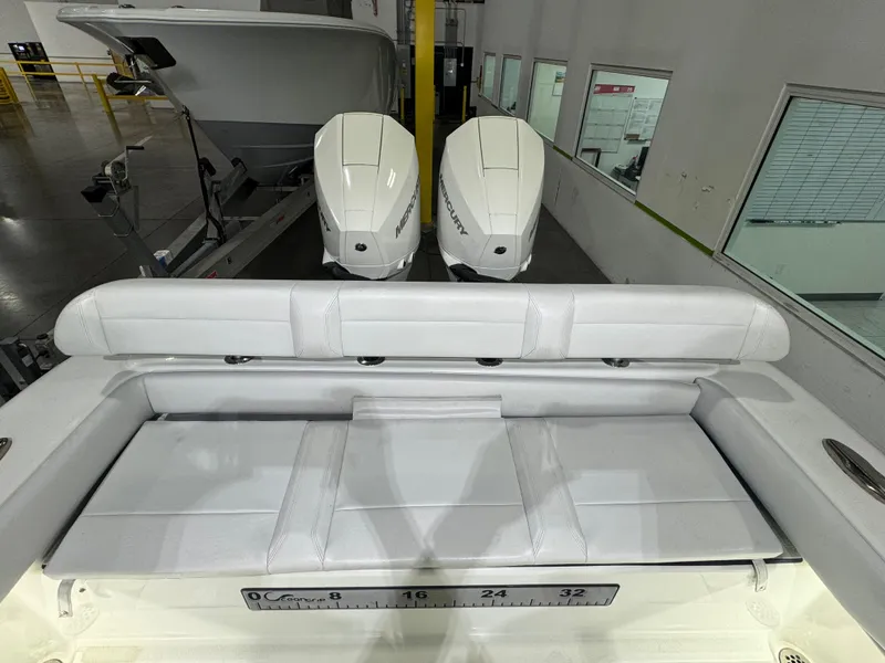 Slide: The Image of 2019 Yellowfin 26 Hybrid boat with dual outboard engines and cushioned seating. - 18