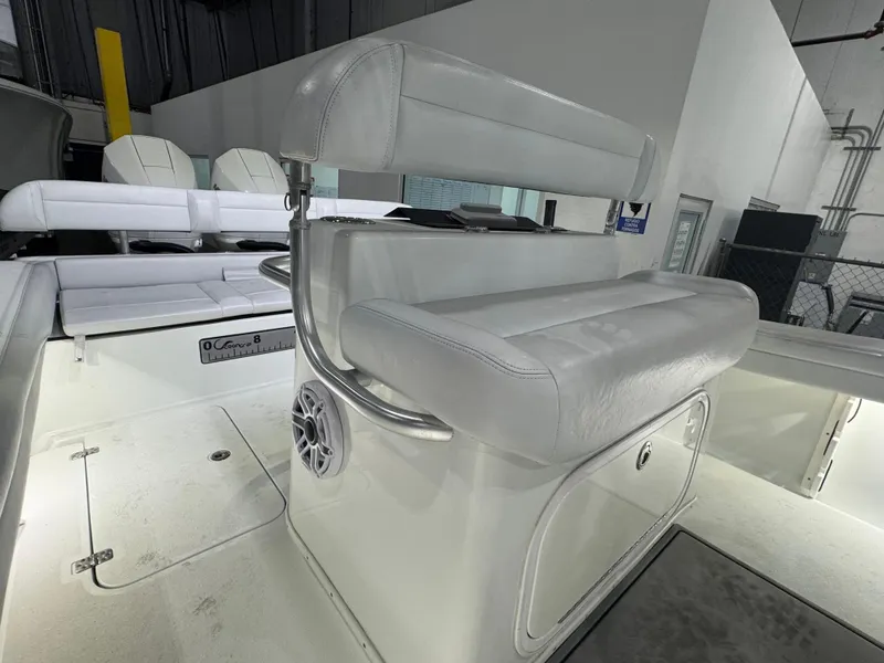 Slide: The Image of 2019 Yellowfin 26 Hybrid boat interior with white seating and storage compartment. - 19