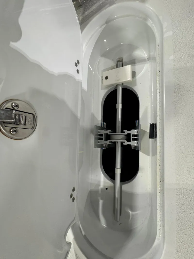 Slide: The Image of 2019 Yellowfin 26 Hybrid boat compartment with latch and storage space. - 26