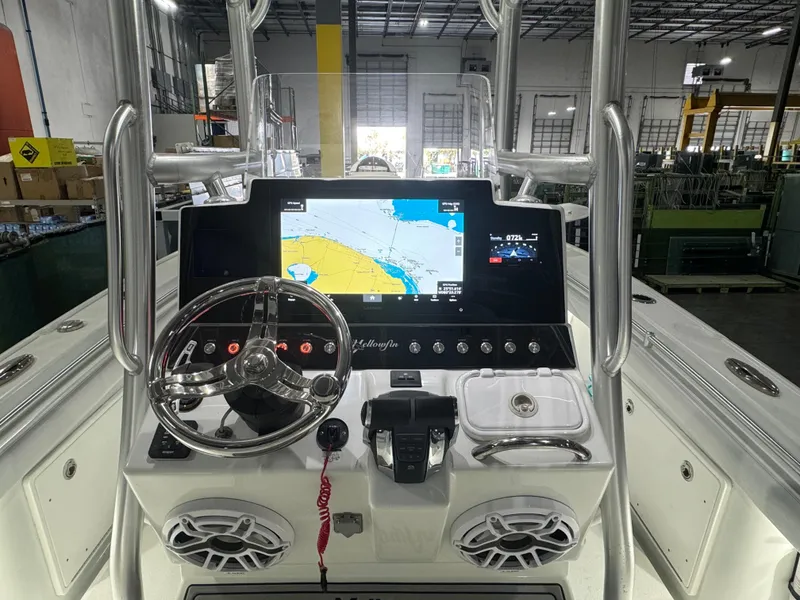 Slide: The Image of 2019 Yellowfin 26 Hybrid boat dashboard with navigation display and steering wheel. - 7