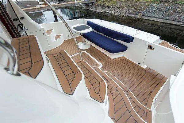 Slide: The Image of 2005 Sea Ray 520 Sedan Bridge yacht with teak deck and cushioned seating. - 11