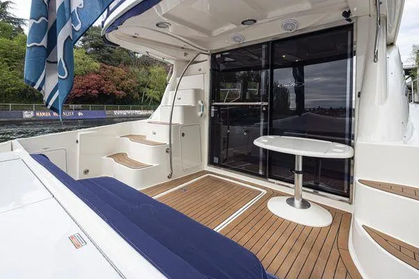 Slide: The Image of 2005 Sea Ray 520 Sedan Bridge yacht with teak deck and seating area. - 14