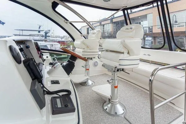 Slide: The Image of 2005 Sea Ray 520 Sedan Bridge helm with luxurious seating and modern controls. - 20