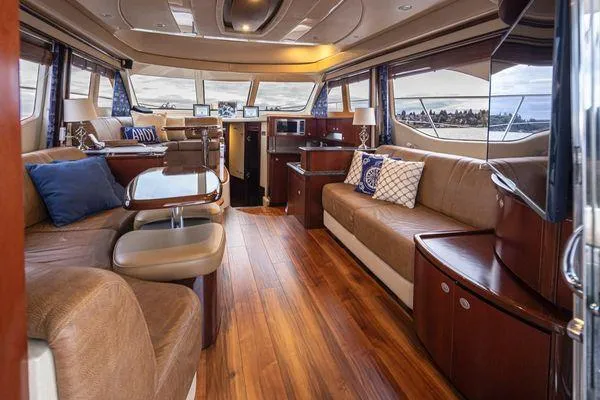 Slide: The Image of Luxurious interior of 2005 Sea Ray 520 Sedan Bridge yacht with elegant seating and wood flooring. - 28