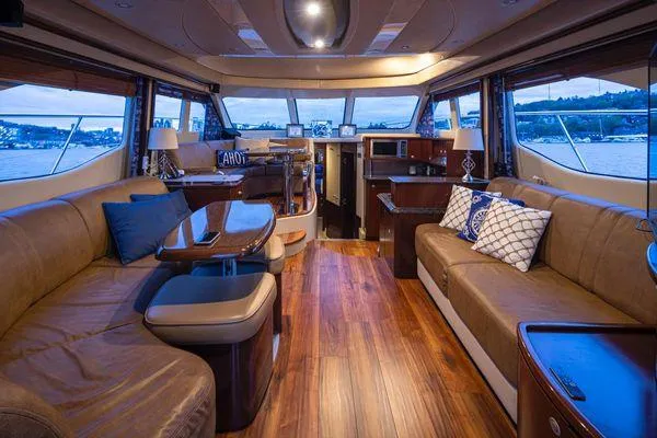 Slide: The Image of Luxurious interior of 2005 Sea Ray 520 Sedan Bridge yacht with elegant seating and wood flooring. - 29