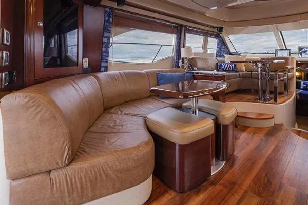 Slide: The Image of Luxurious interior of 2005 Sea Ray 520 Sedan Bridge yacht with plush seating and wooden flooring. - 30